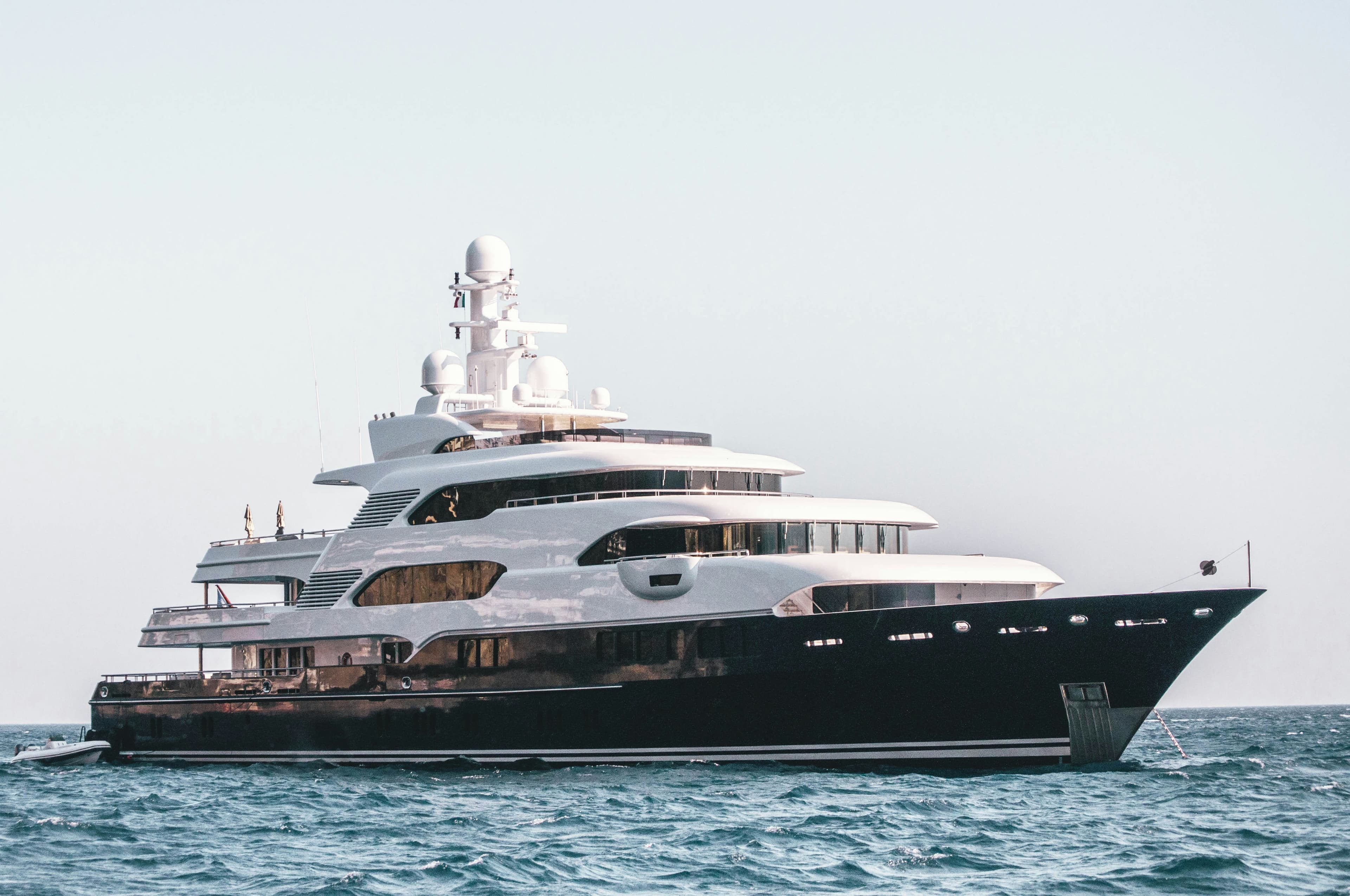 Modern yacht against a coastal backdrop